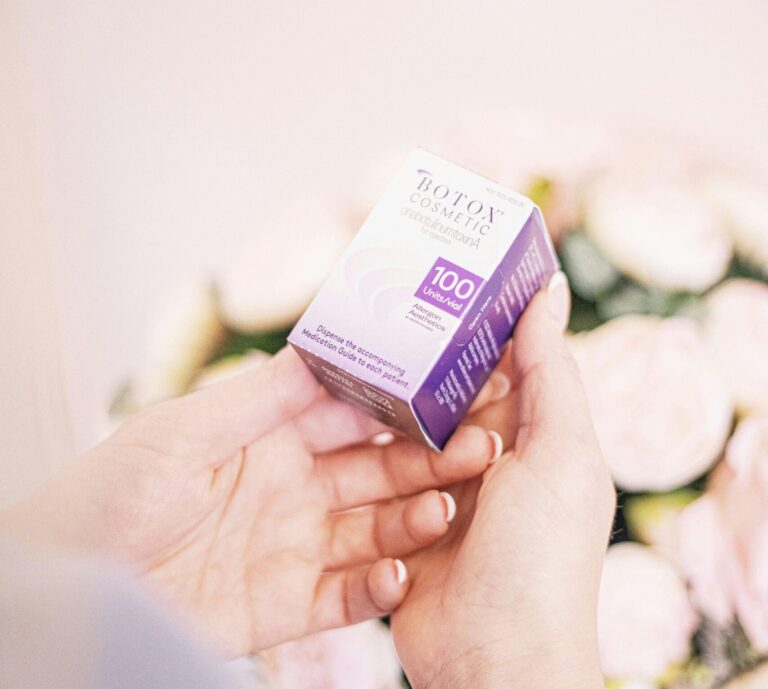 Close-up of hands holding Botox Cosmetic box, embodying beauty and wellness.