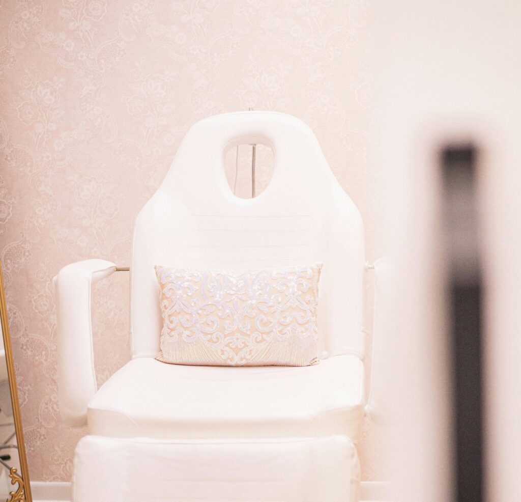 Elegant spa chair in a minimalist, pink-toned beauty clinic in Brevard, NC.
