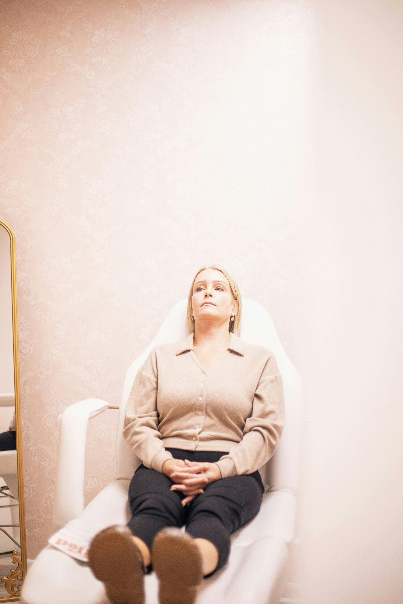 Woman enjoying a peaceful moment in a modern medical spa, highlighting serene ambience and skincare wellness.