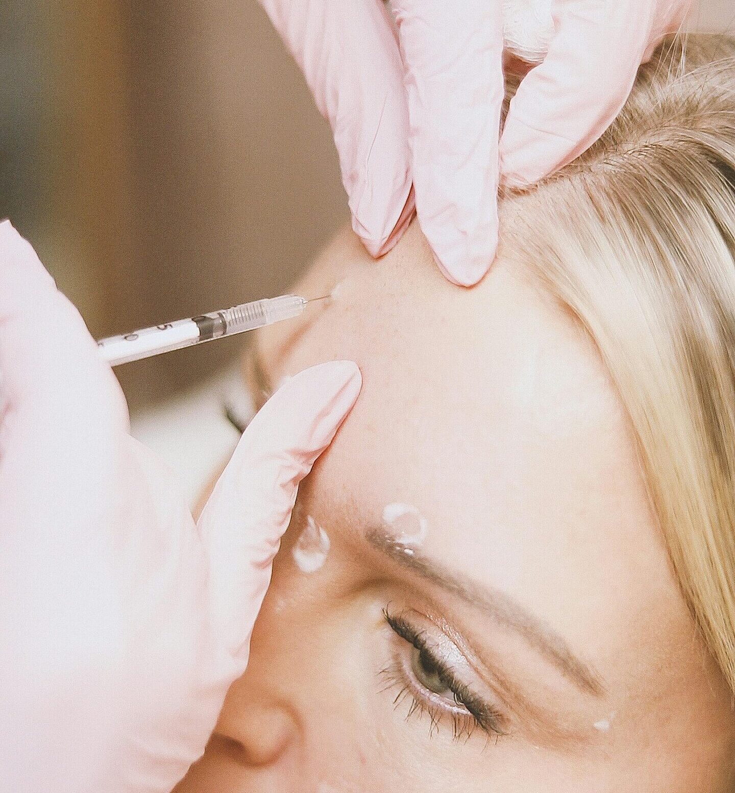 Close-up of a cosmetic injection procedure in a modern spa setting.